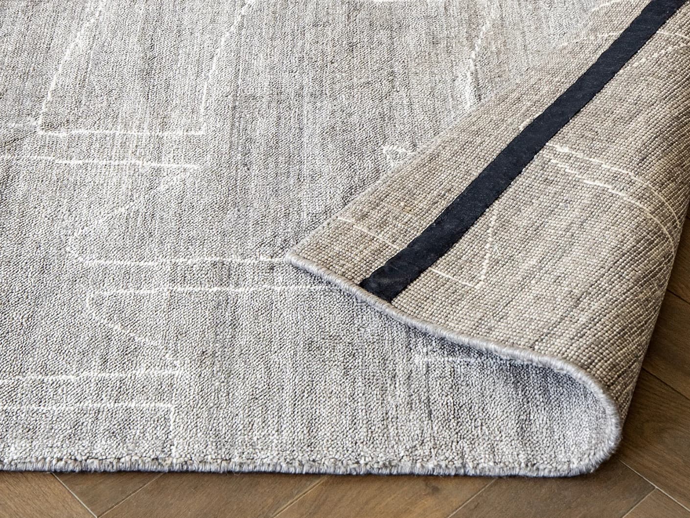 Caleb Dune carpets in dune, grey and blue, shown in a product front view