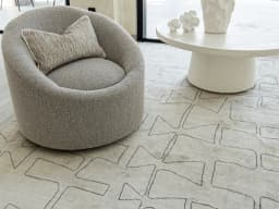 Caleb Ebony carpet in ebony, pearl and grey, shown in a lifestyle close-up front view