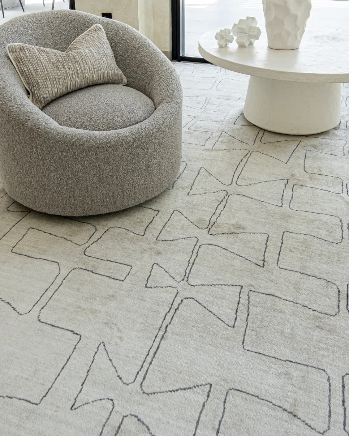 Caleb Ebony Round carpet in ebony, pearl and grey, shown in a lifestyle close-up front view as image 4