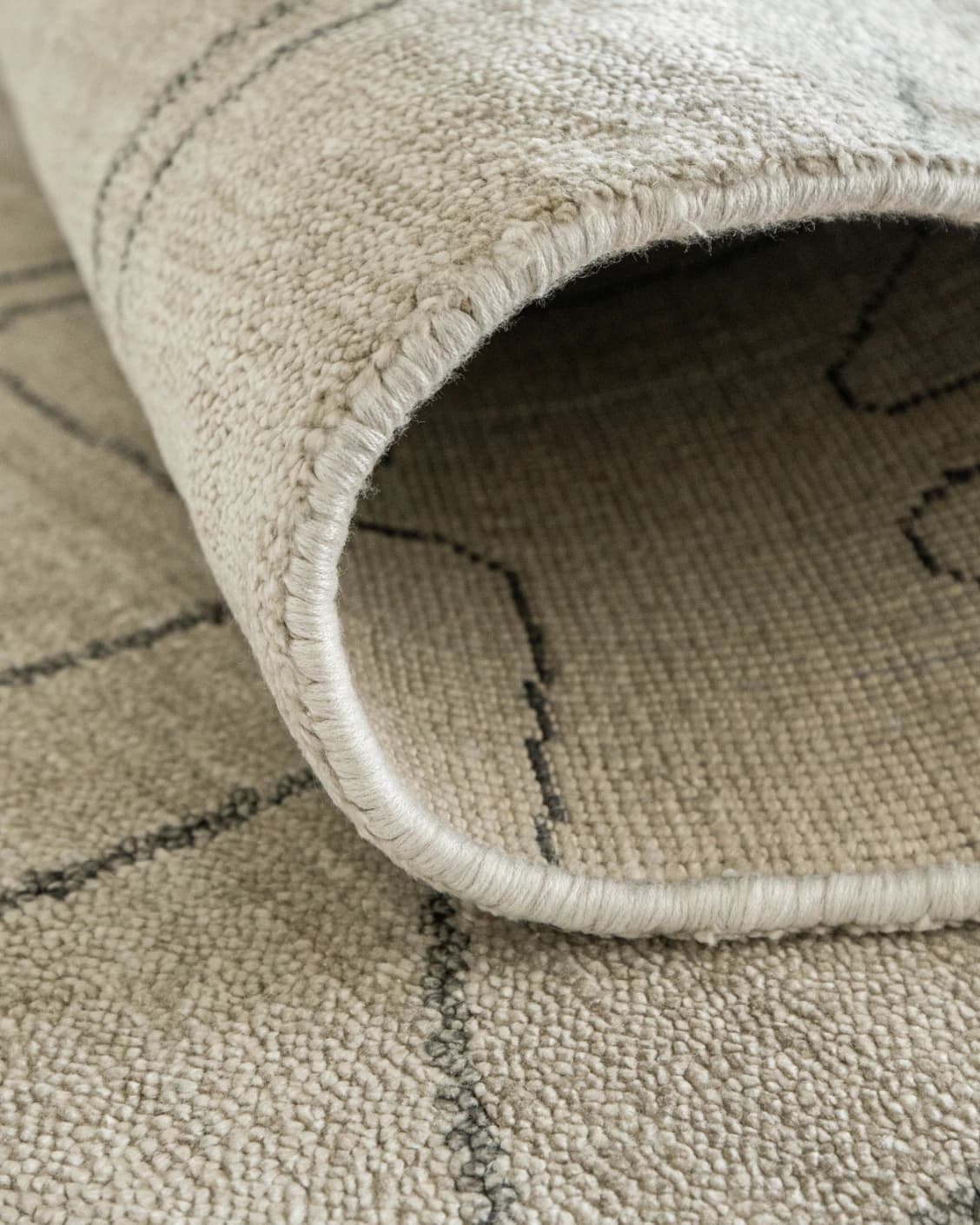 Caleb Ebony Round carpet in ebony, pearl and grey, shown in a lifestyle close-up as image 5