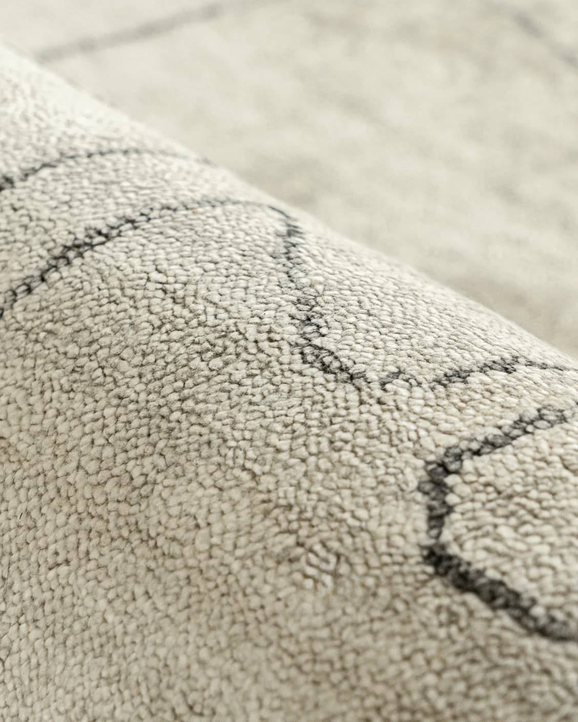 Caleb Ebony Round carpet in ebony, pearl and grey, shown in a lifestyle close-up as image 7