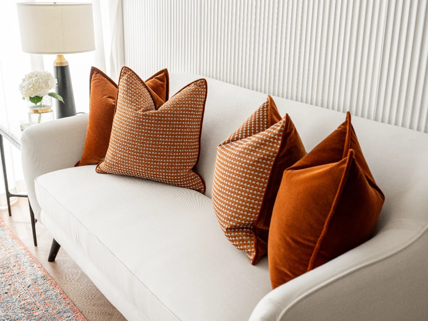 Callan Bundle bundle cushions in rust and orange, shown in a lifestyle front view