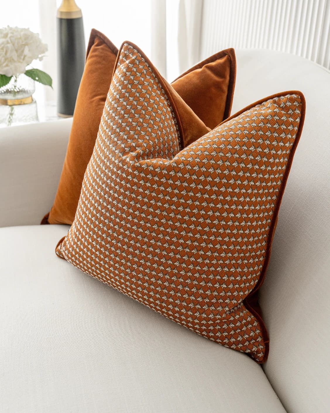 Callan Bundle cushion in rust and orange, shown in a lifestyle front view as image 5