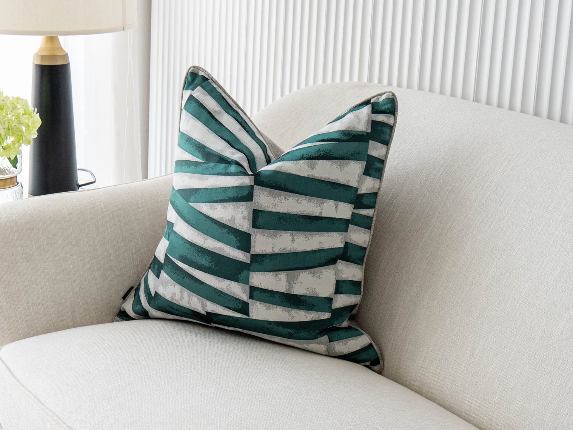 Carlie Teal single cushions in teal, turquoise, blue and green, shown in a lifestyle front view