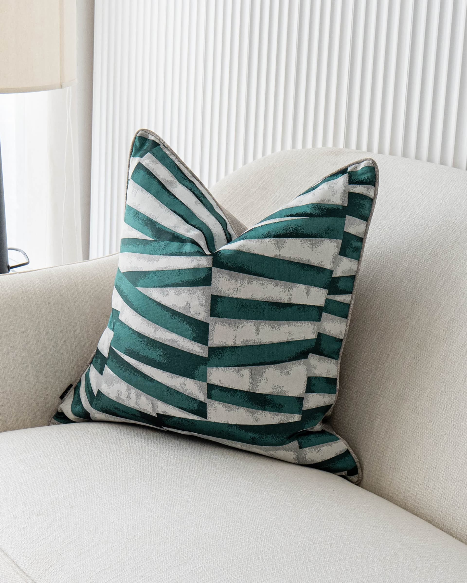 Carlie Teal cushion in teal, turquoise, blue and green, shown in a lifestyle front view as image 2