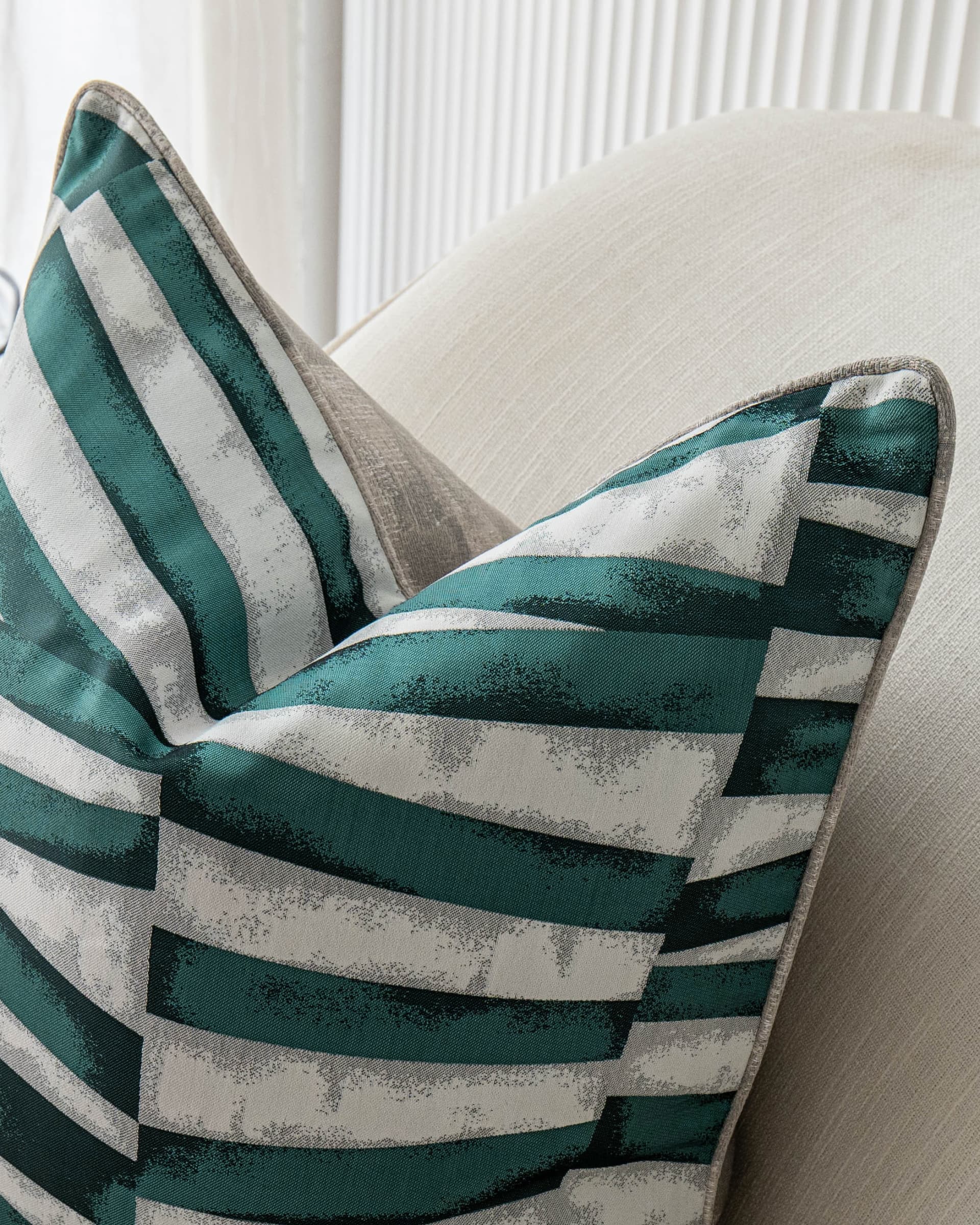 Carlie Teal cushion in teal, turquoise, blue and green, shown in a lifestyle top view as image 5