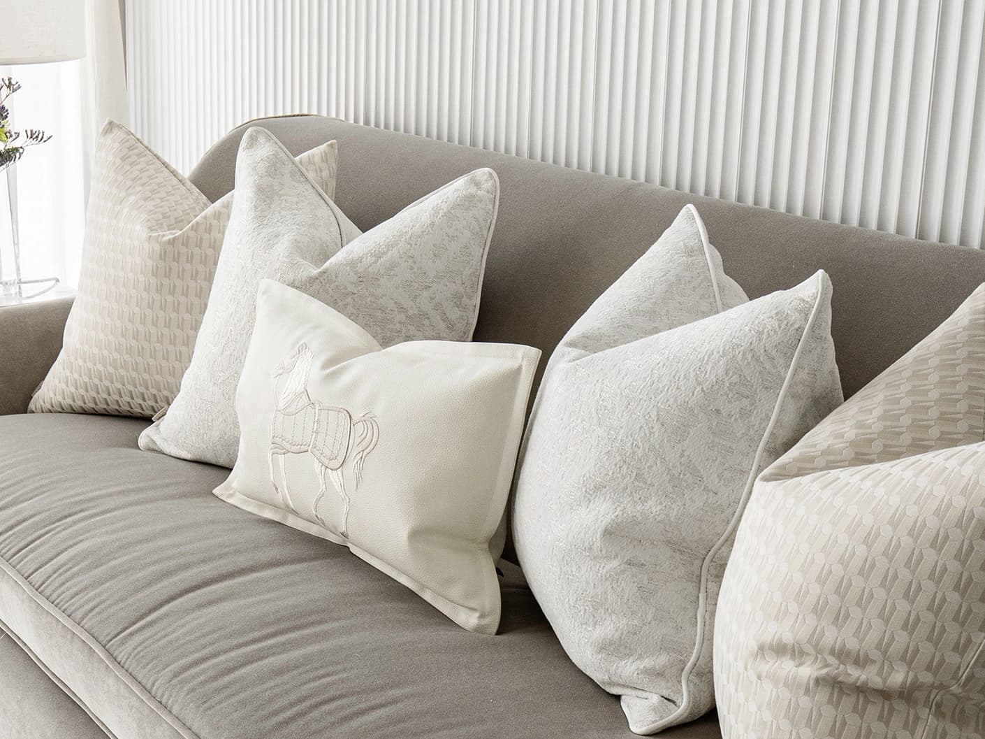 Carmi Bundle bundle cushions in white and beige, shown in a lifestyle front view