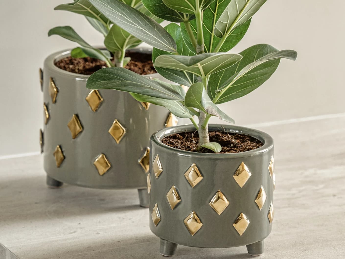Caspian Arneson Bundle vases in grey and gold, shown in a lifestyle right view