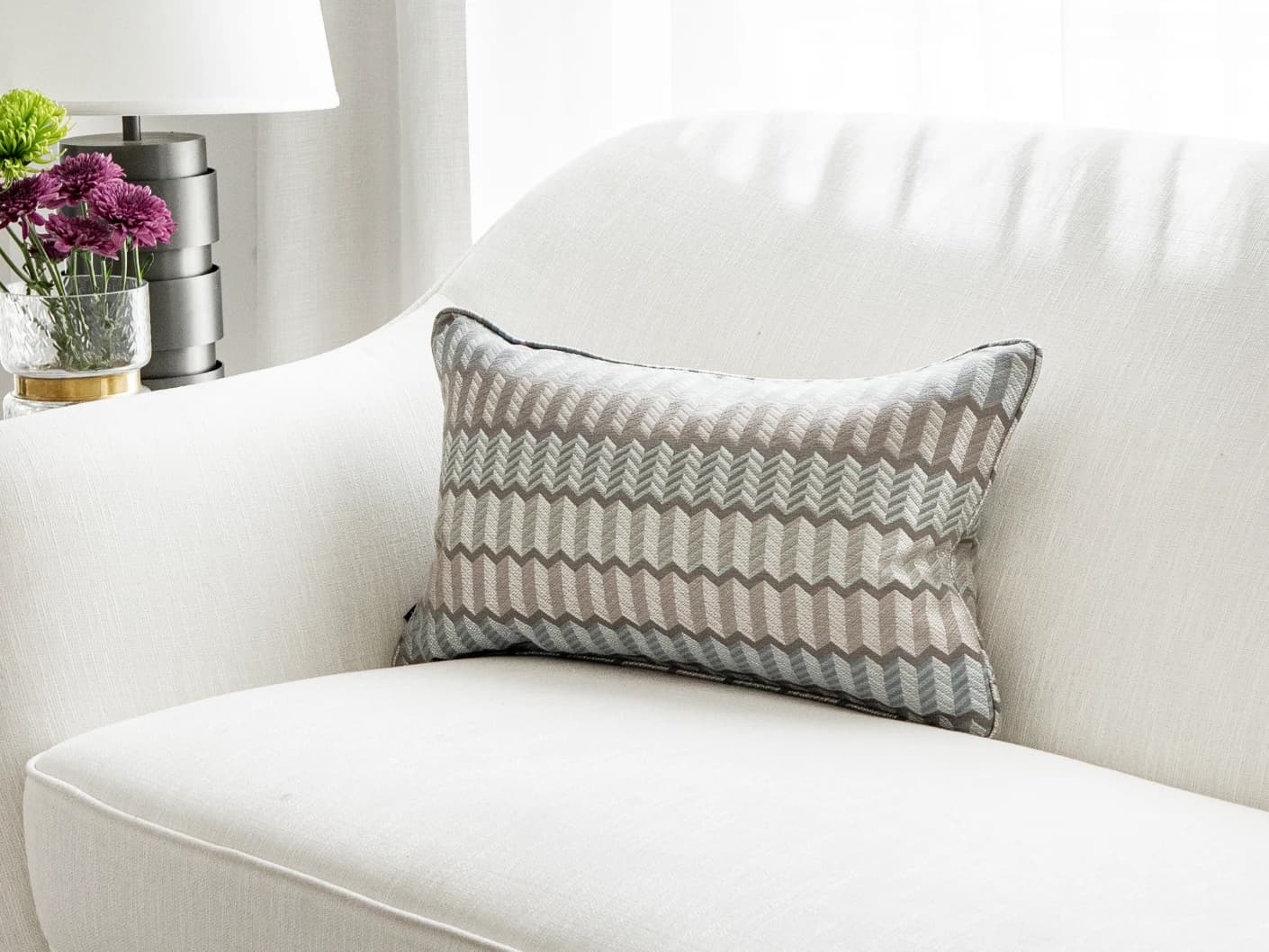 Cecilia Canova II single cushions in silver, blue and multicolour, shown in a lifestyle right view