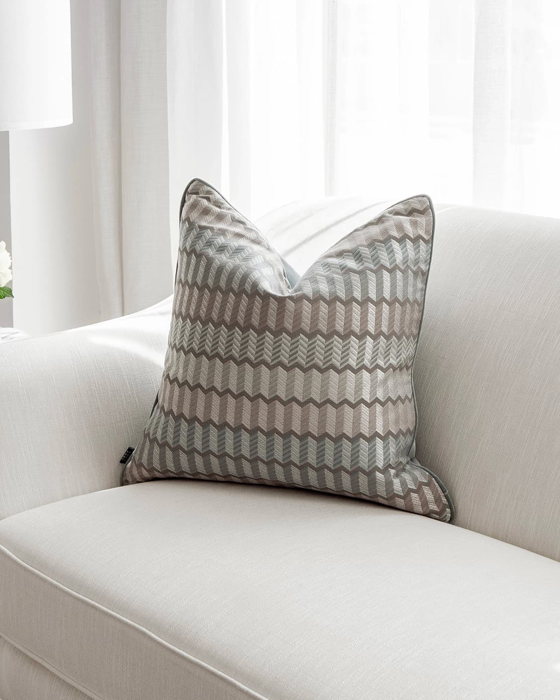 Cecilia Canova cushion in silver, blue and multicolour, shown in a lifestyle front view as image 2