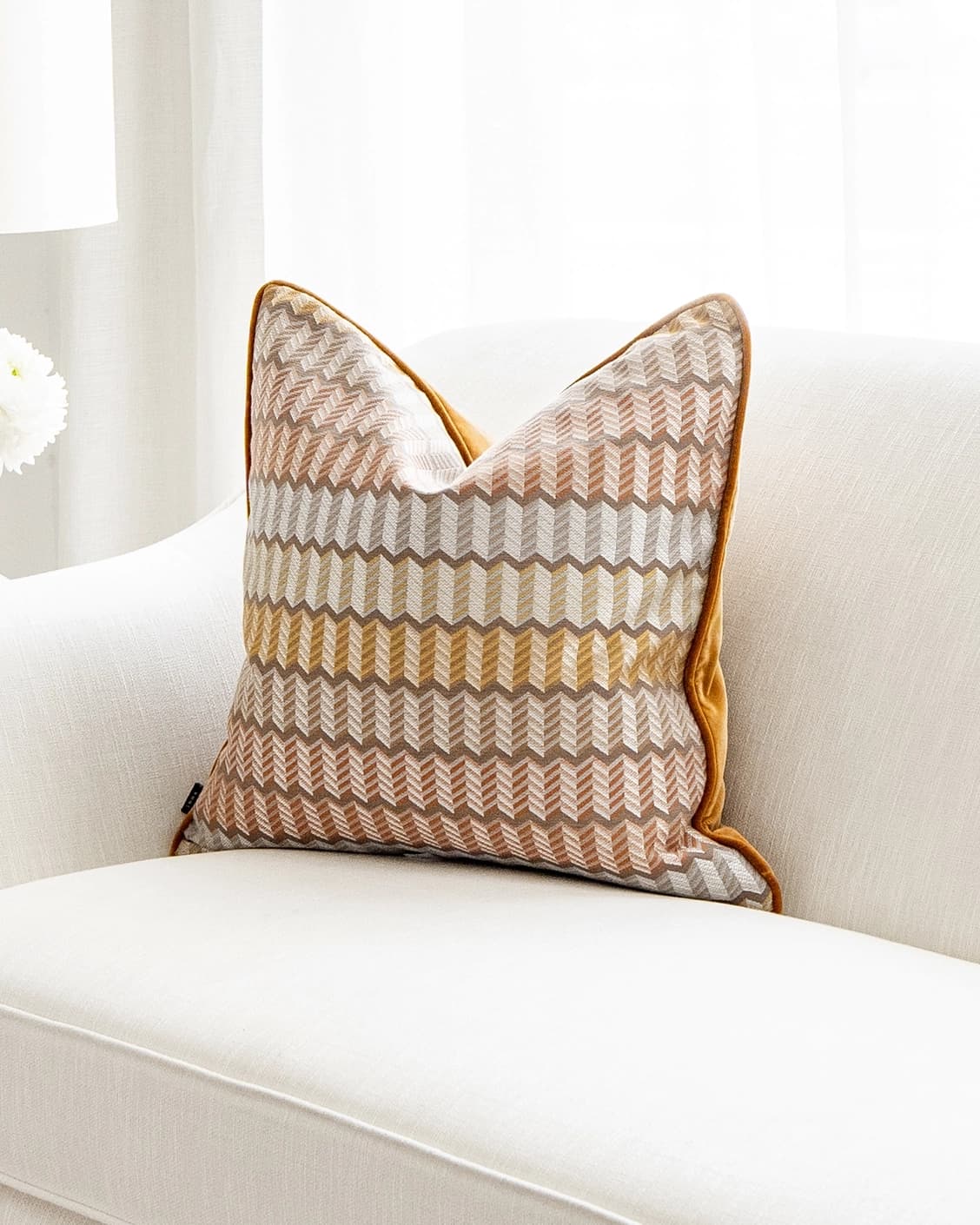 Cecilia Hodler cushion in orange, yellow and multicolour, shown in a lifestyle front view as image 2