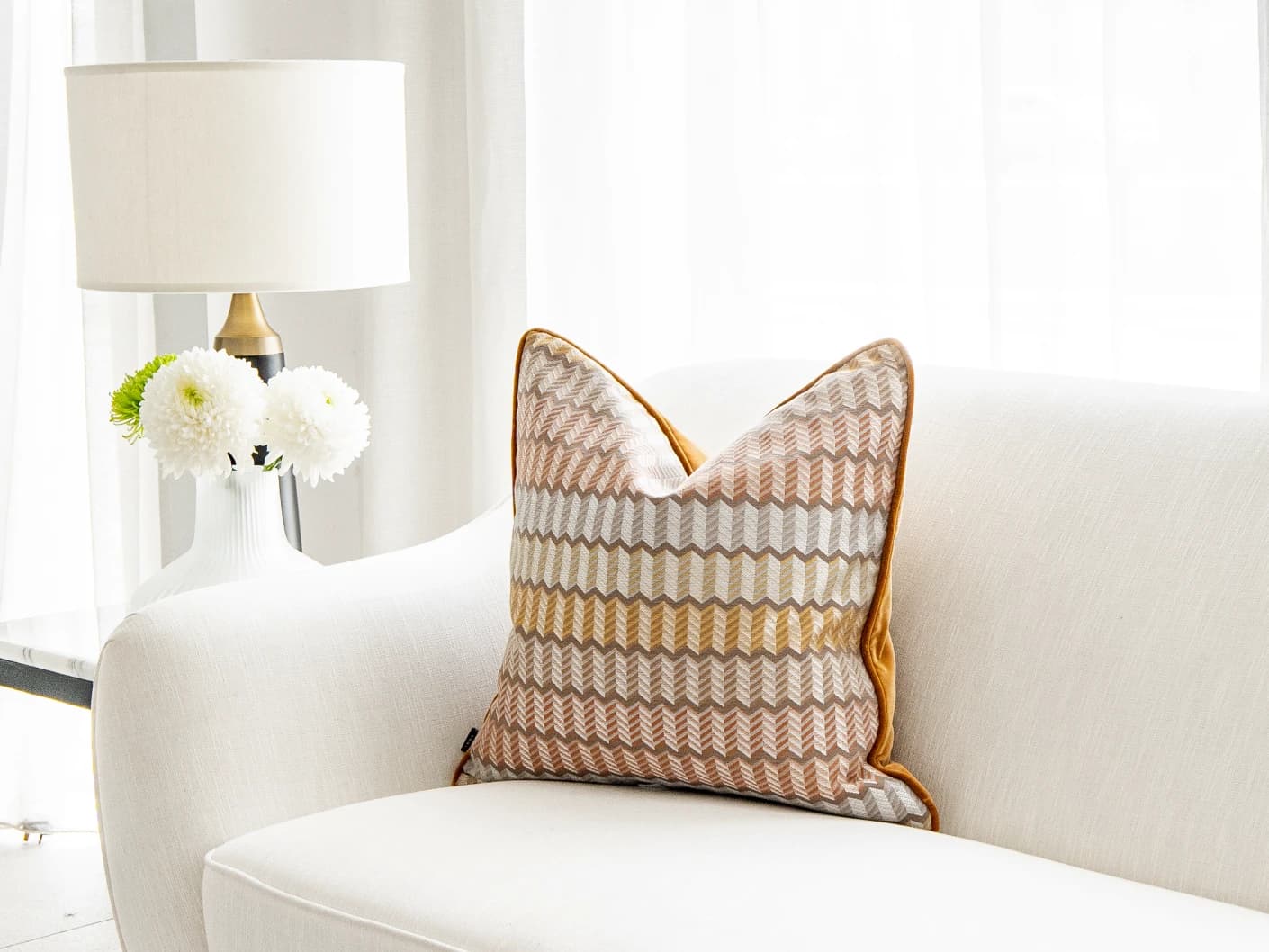 Cecilia Hodler single cushions in orange, yellow and multicolour, shown in a lifestyle front view