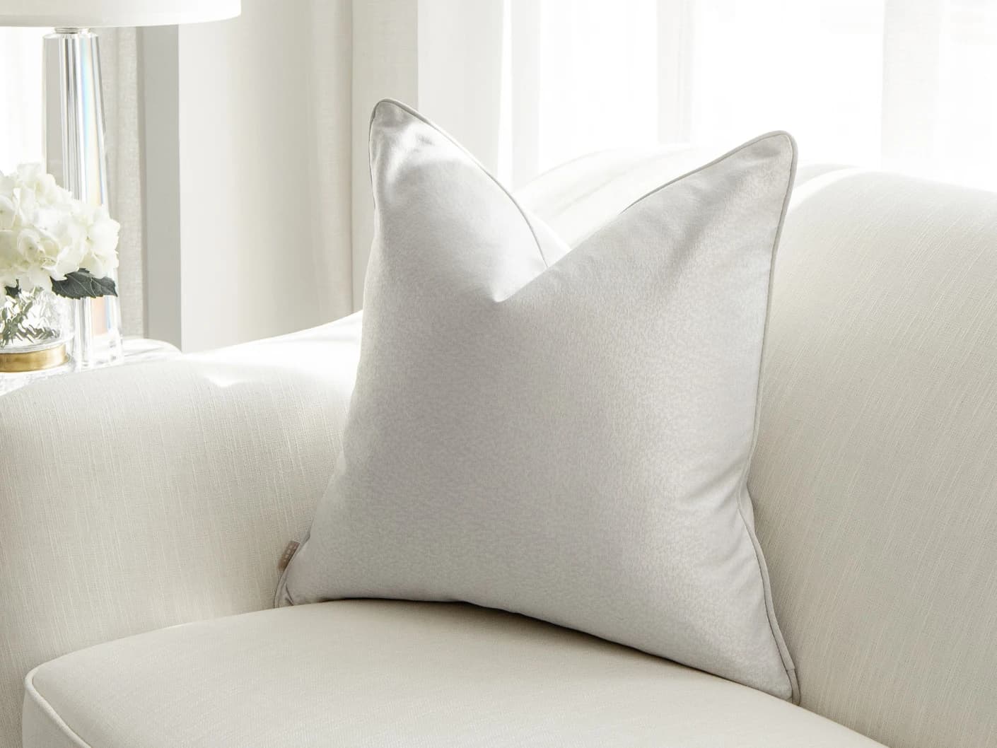 Celeste Hodler single cushions in silver, shown in a lifestyle front view