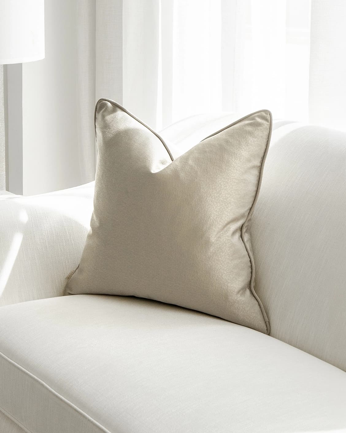 Celeste Laurent cushion in gold and beige, shown in a lifestyle front view as image 2