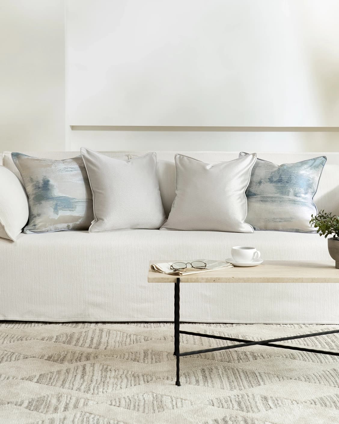 Celia Bundle cushion in blue and silver, shown in a lifestyle front view as image 4