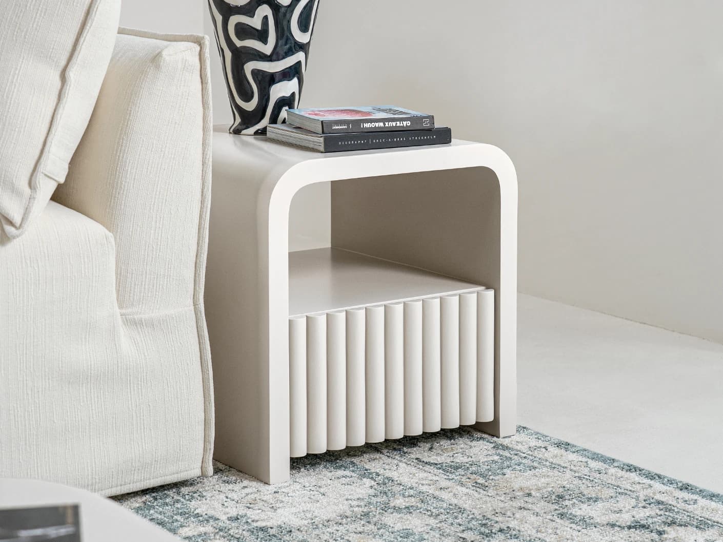 Celia nightstand in soft ivory and stone, shown in a lifestyle left view