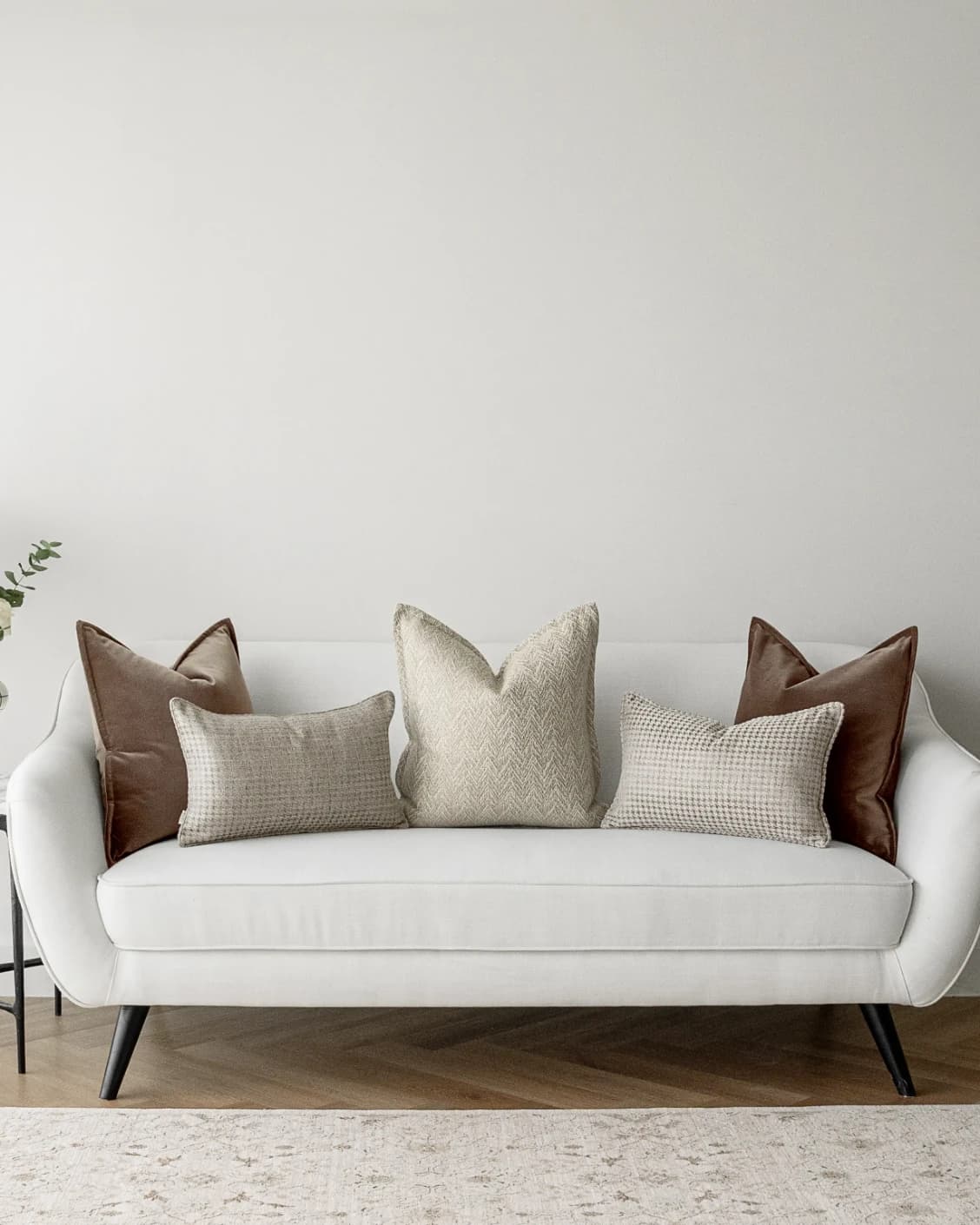 Cente Bundle cushion in brown, beige and silver, shown in a lifestyle front view as image 2