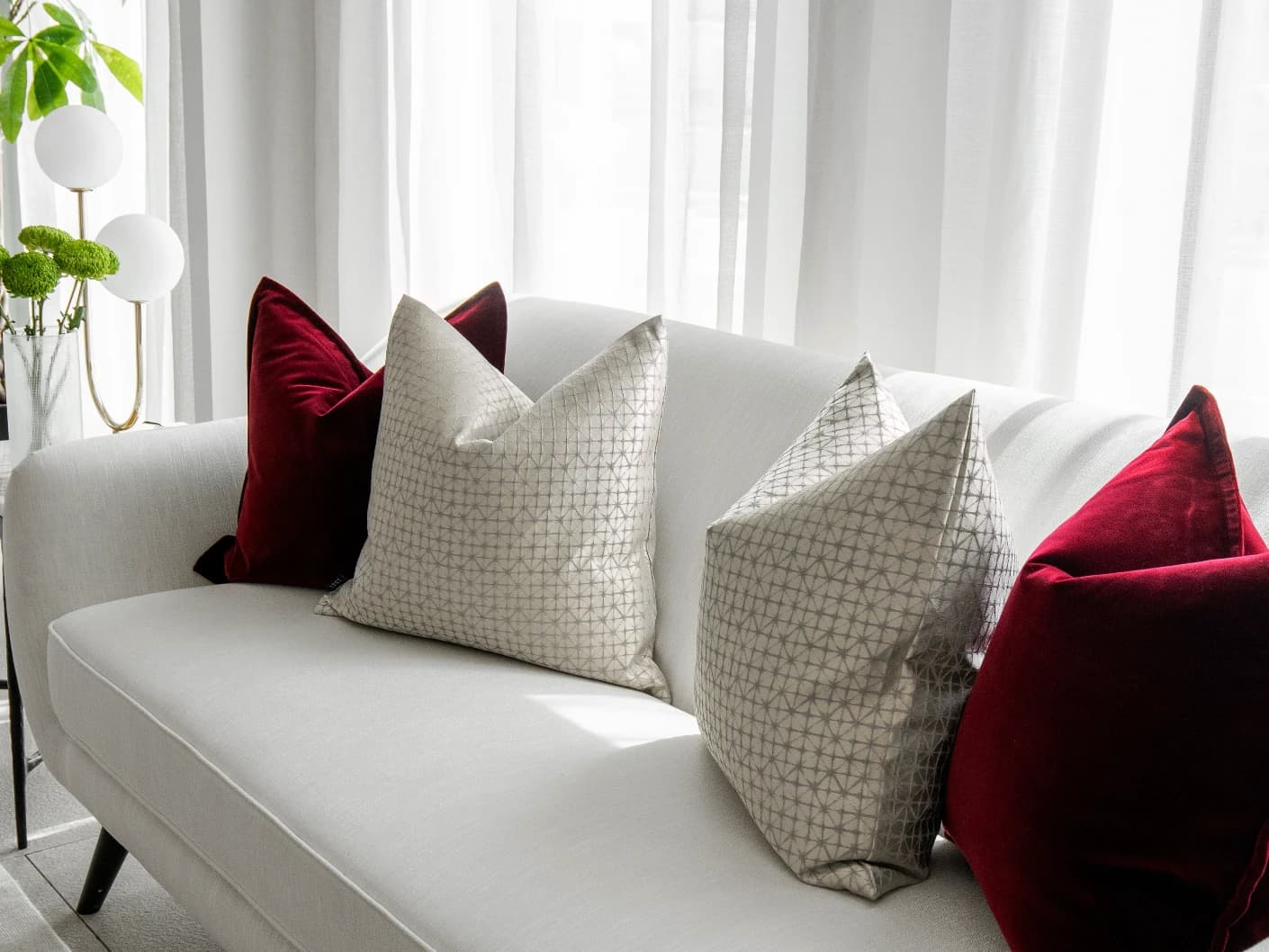 Cerise Bundle bundle cushions in red, silver and white, shown in a lifestyle front view