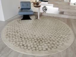 Chess Dune Round carpet in dune, taupe and beige, shown in a lifestyle front view