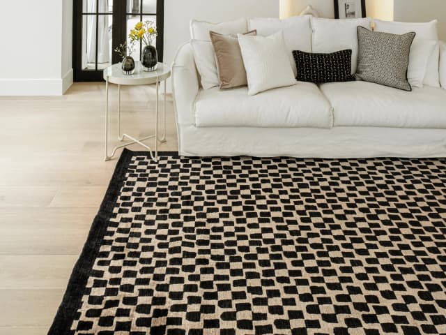 Chess Ebony carpets in beige and black, shown in a lifestyle close-up top view as image 1