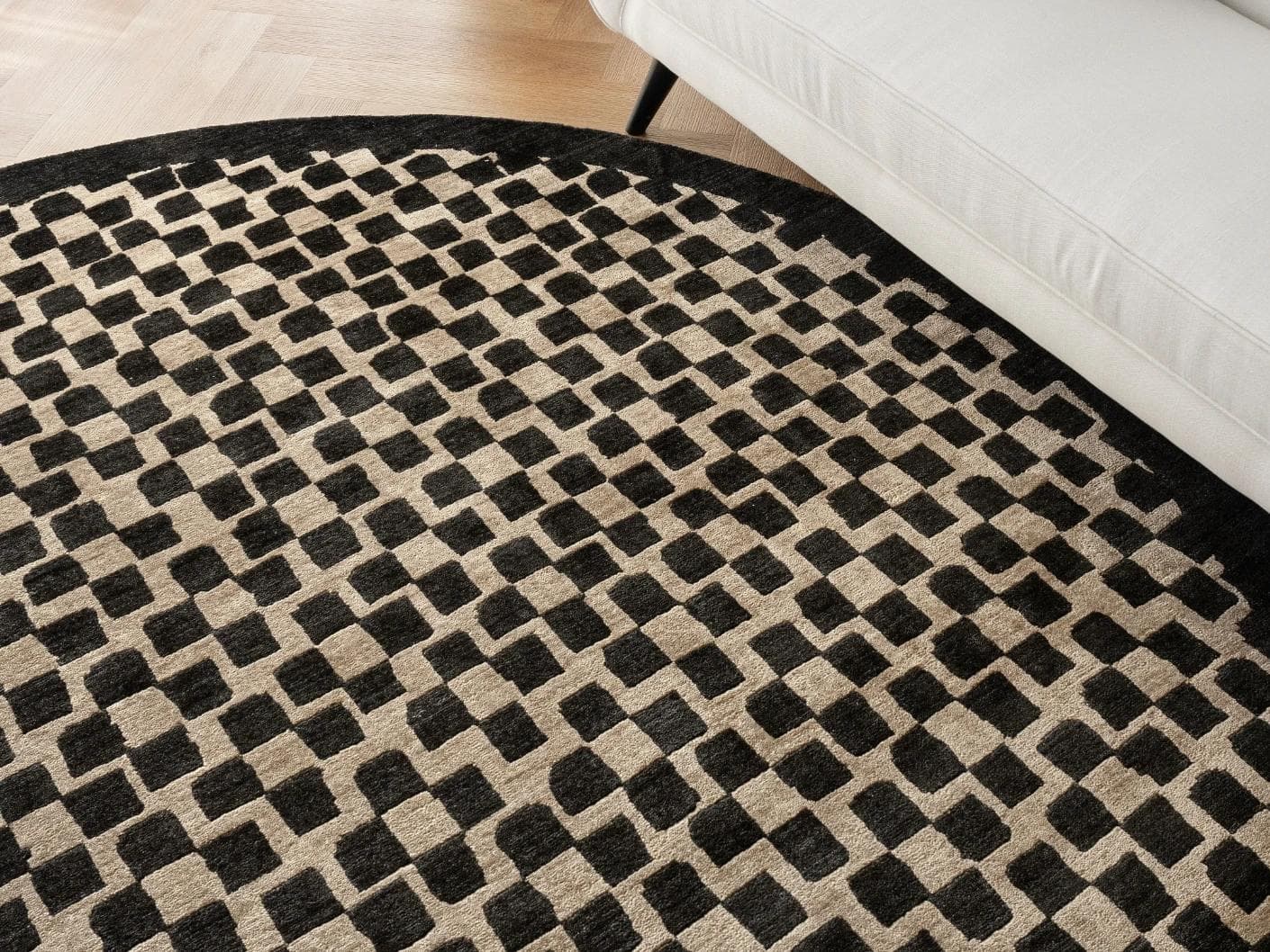 Chess Ebony carpets in beige and black, shown in a lifestyle close-up top view as image 1