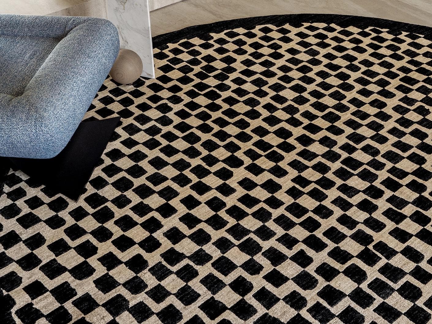 Chess Ebony carpets in beige and black, shown in a lifestyle close-up top view as image 2