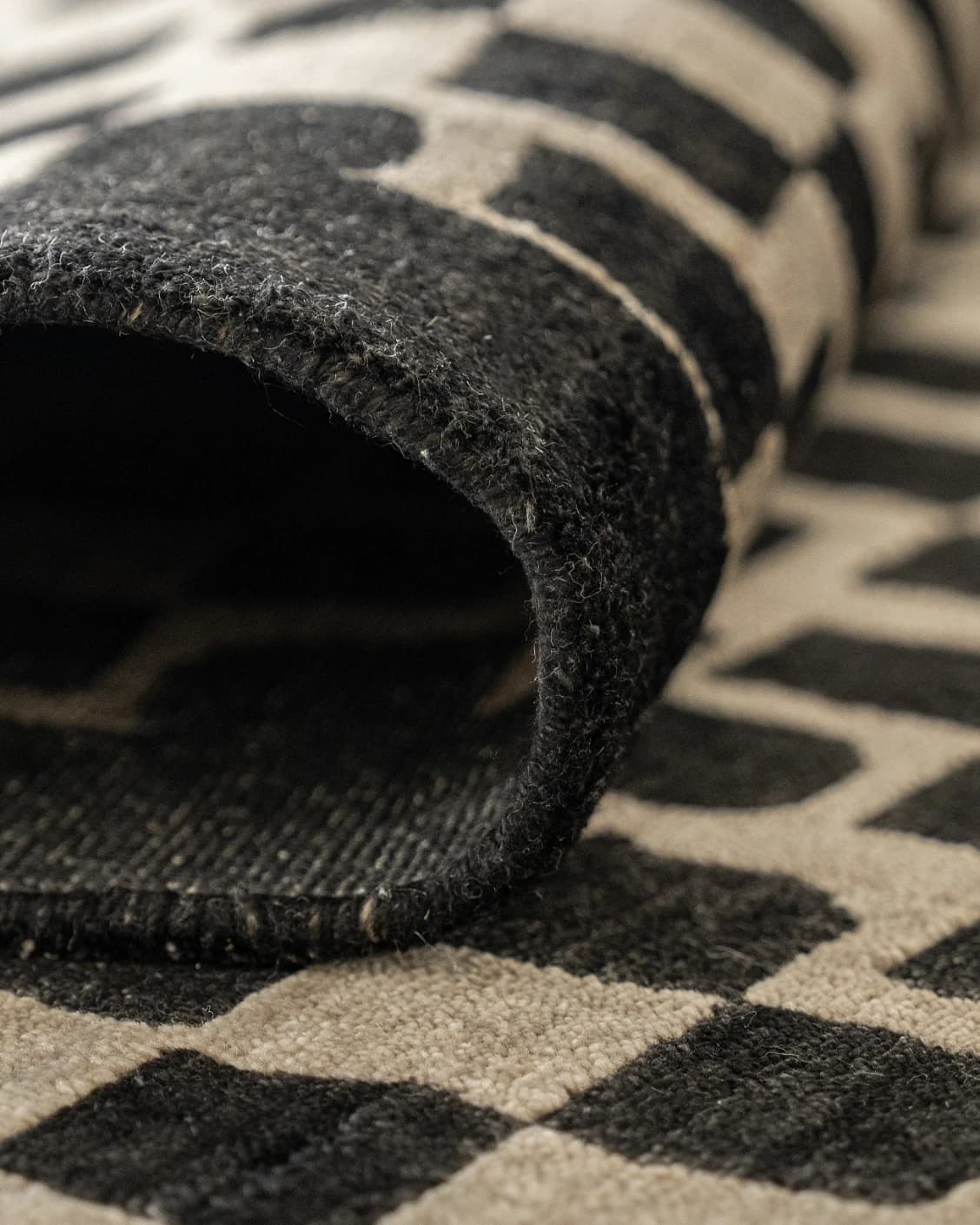 Chess Ebony carpet in beige and black, shown in a lifestyle close-up front view as image 4