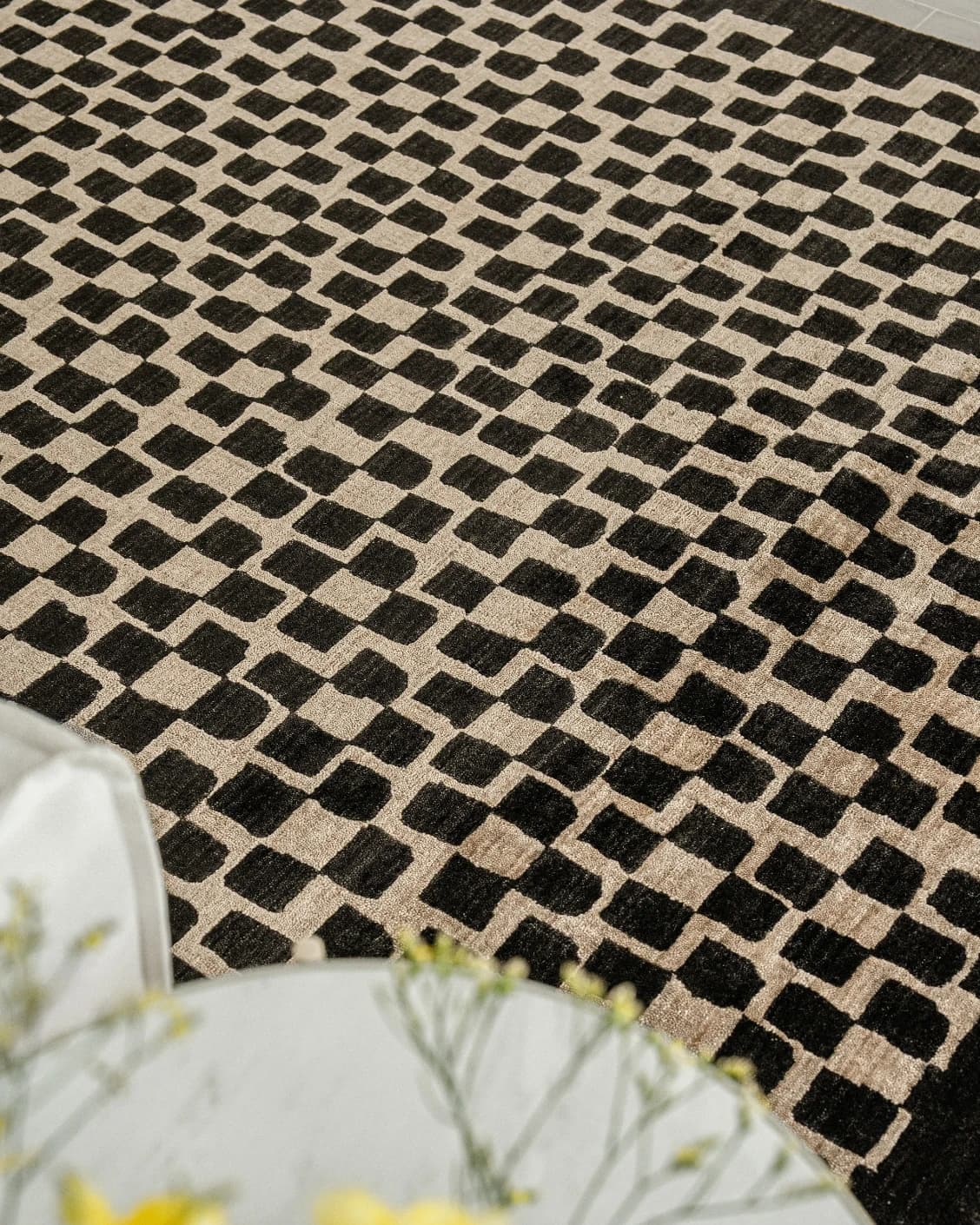 Chess Ebony carpet in beige and black, shown in a lifestyle close-up top view as image 5