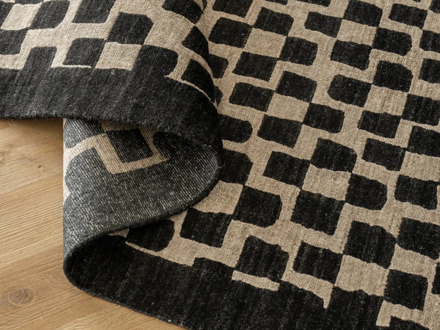 Chess Ebony carpets in ebony, beige and black, shown in a product close-up top view