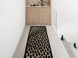 Chess Ebony Runners carpet in beige and black, shown in a lifestyle front view
