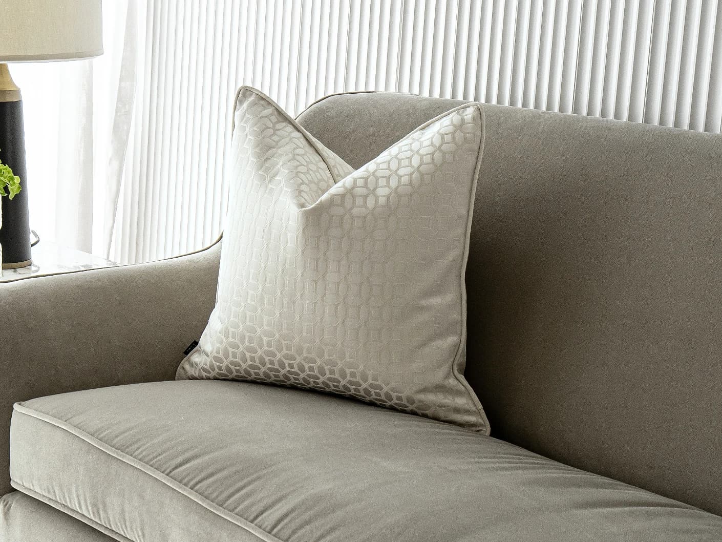 Cillian Bianca single cushions in white, shown in a lifestyle front view