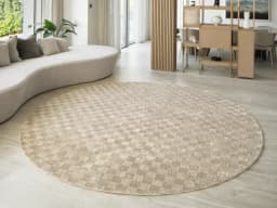 Cindy Dune Round carpet in taupe and beige, shown in a lifestyle front view