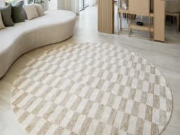 Cindy Tan Round carpet in taupe and beige, shown in a lifestyle front view