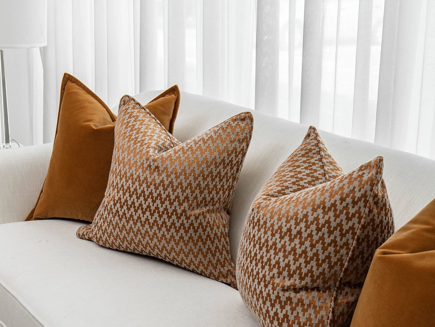 Cleopatra Bundle bundle cushions in orange, shown in a lifestyle front view