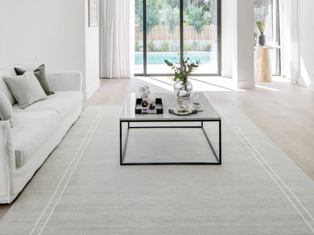 Colin Alba Round carpet in white and grey, shown in a lifestyle close-up top view as image 4