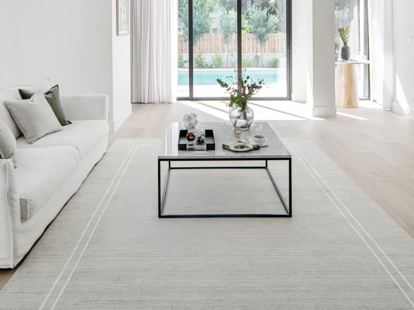 Colin Alba Round carpet in white and grey, shown in a lifestyle close-up top view as image 4