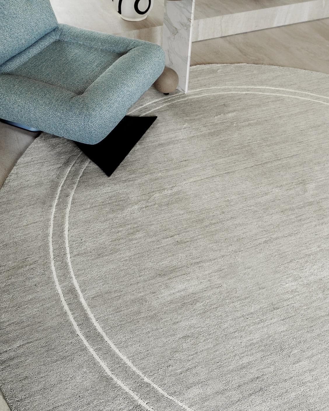 Colin Alba Round carpet in white and grey, shown in a lifestyle close-up top view as image 4