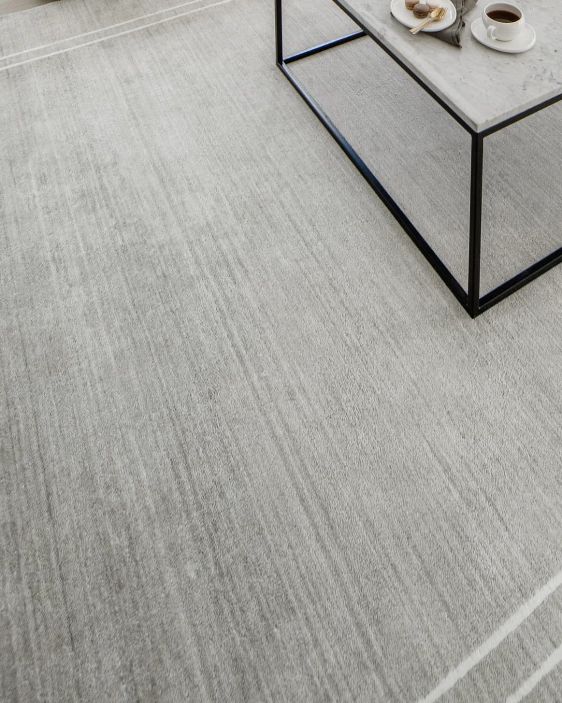 Colin Alba carpet in white and grey, shown in a lifestyle close-up as image 8