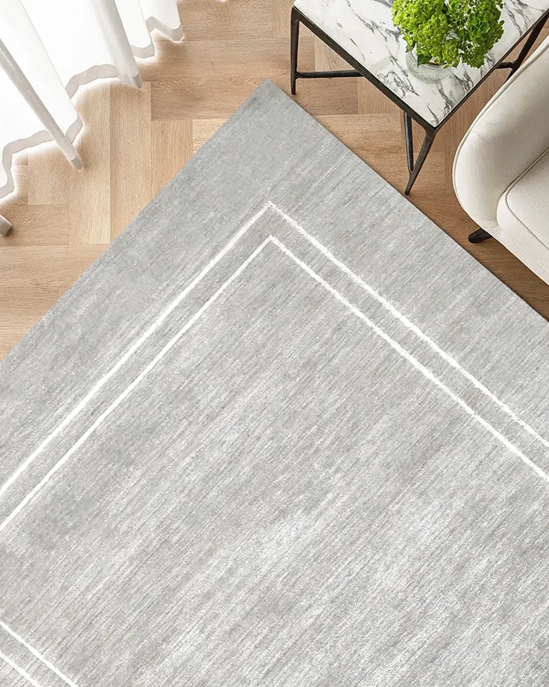 Colin Alba carpet in white and grey, shown in a lifestyle top view as image 2