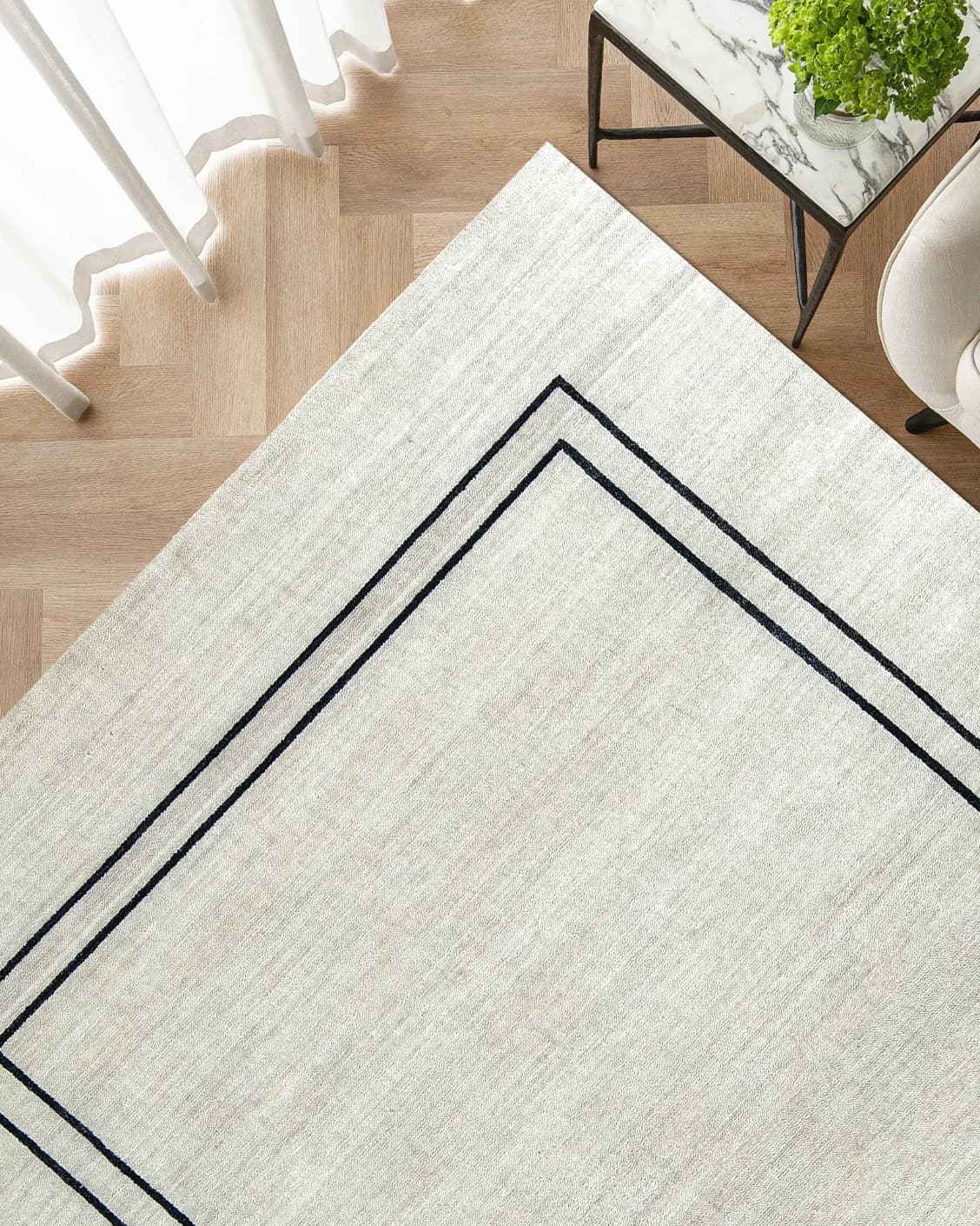 Colin Bianca carpet in white, black and pearl, shown in a lifestyle front view as image 2