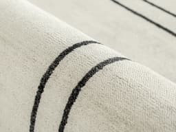 Colin Bianca carpet in white, black and pearl, shown in a product close-up front view