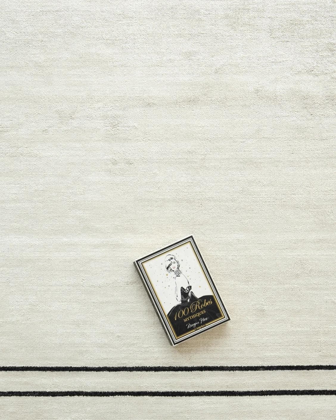 Colin Bianca Round carpet in white, black and pearl, shown in a lifestyle top view as image 6