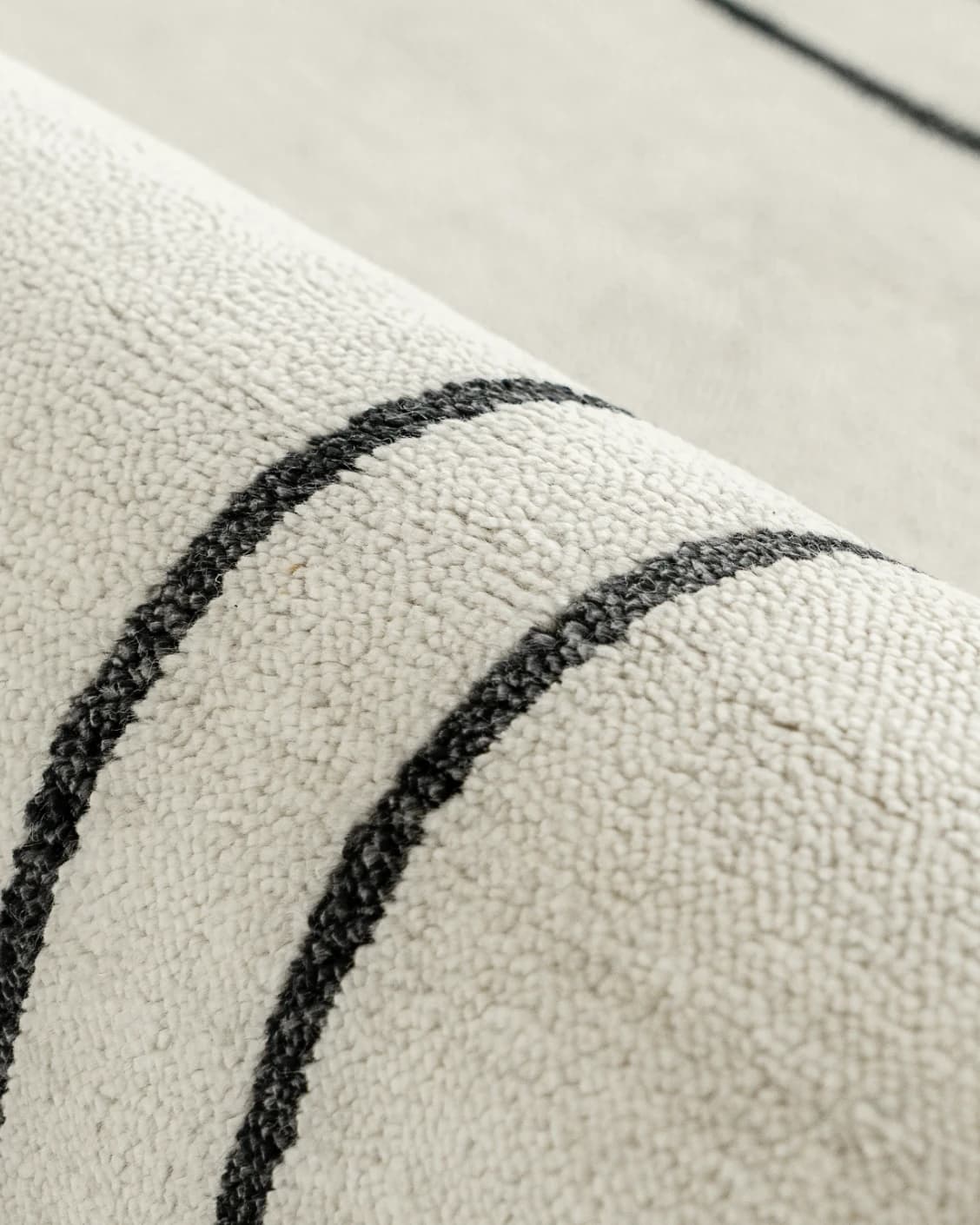 Colin Bianca carpet in white, black and pearl, shown in a product close-up front view