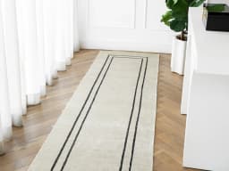 Colin Bianca Runners carpet in white, black and pearl, shown in a lifestyle front view