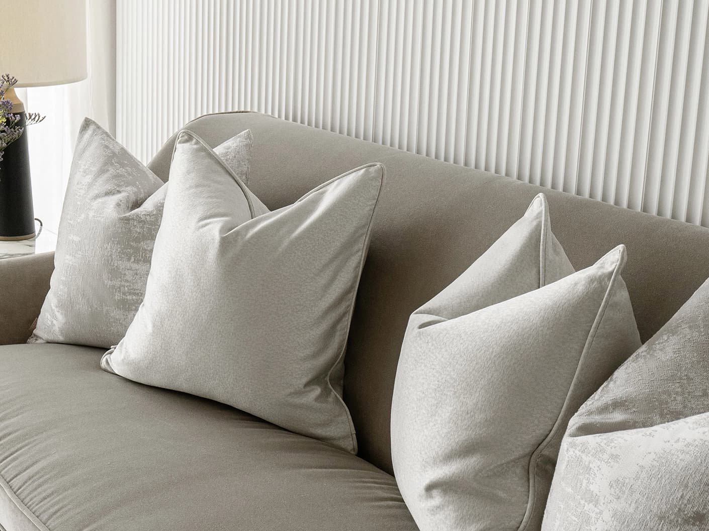 Colin Bundle bundle cushions in silver and grey, shown in a lifestyle front view
