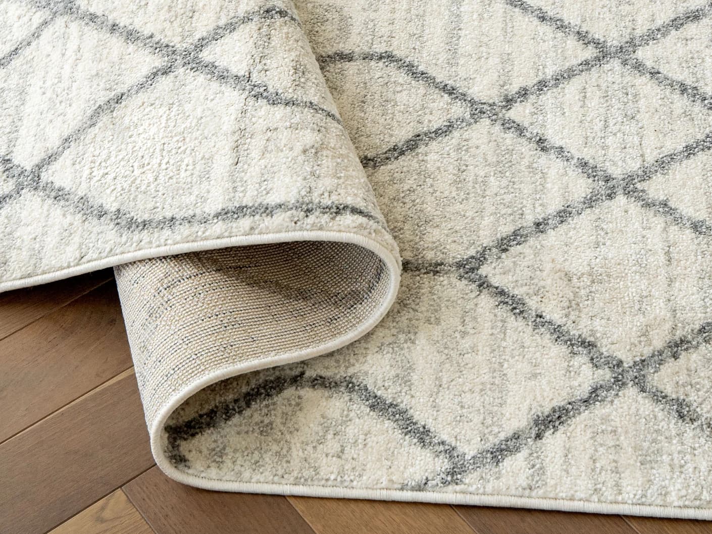 Conrad Lily carpets in ivory and grey, shown in a product top view