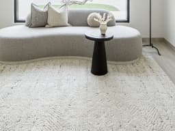 Conrad Sandy carpet in sandy, beige and grey, shown in a lifestyle front view