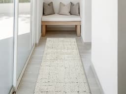 Conrad Sandy Runners carpet in beige and grey, shown in a lifestyle front view