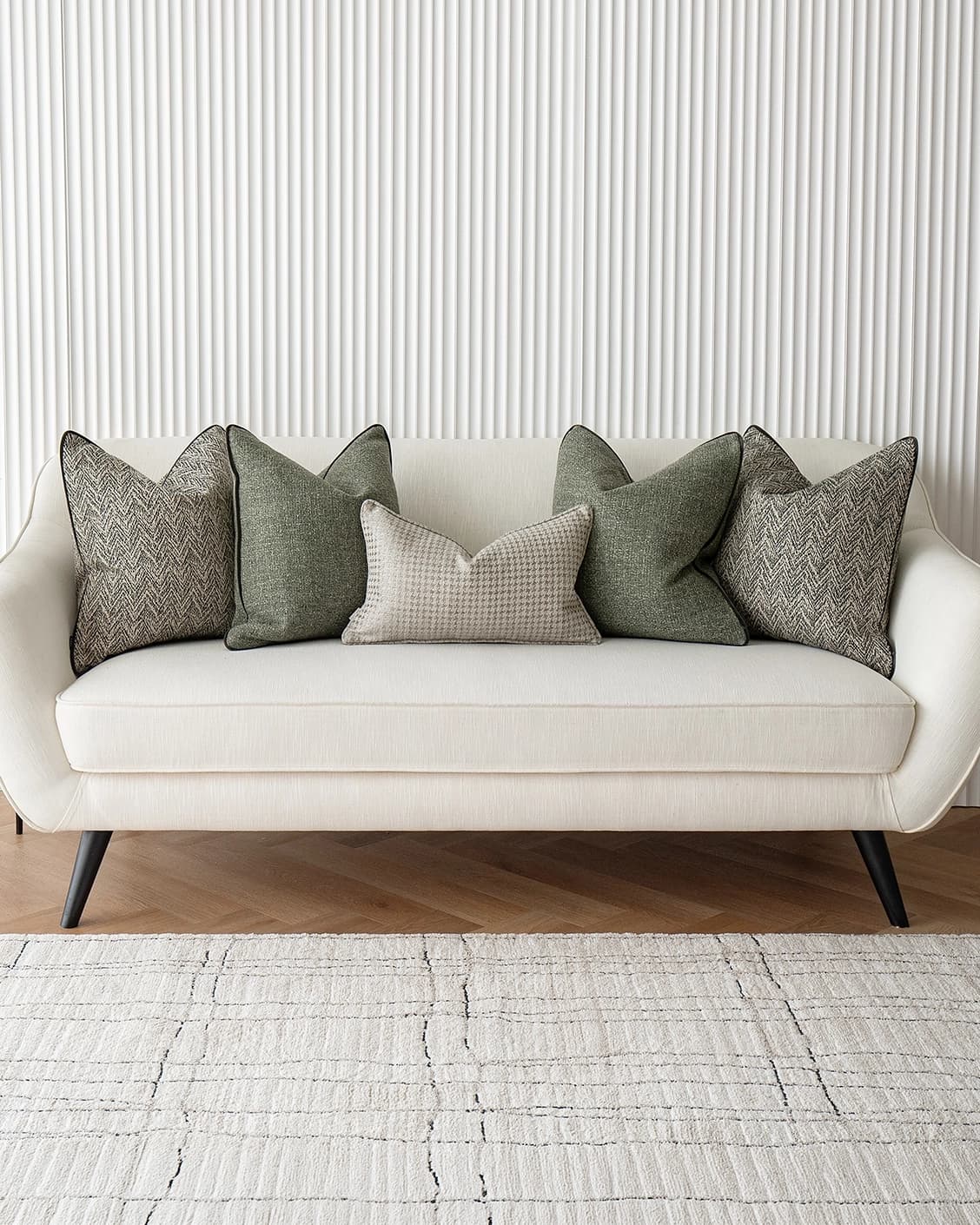 Constantine Bundle cushion in brown, shown in a lifestyle front view as image 2