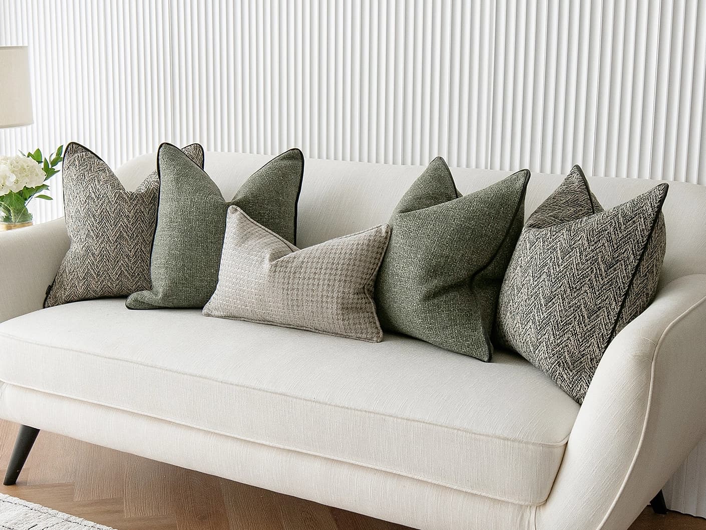 Constantine Bundle bundle cushions in brown, shown in a lifestyle front view
